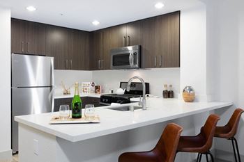 A kitchen with a counter top and a refrigerator